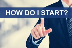 Man pointing to a sticky note labeled “How do I start?” symbolizing the challenge ADHD adults face when transitioning between tasks.