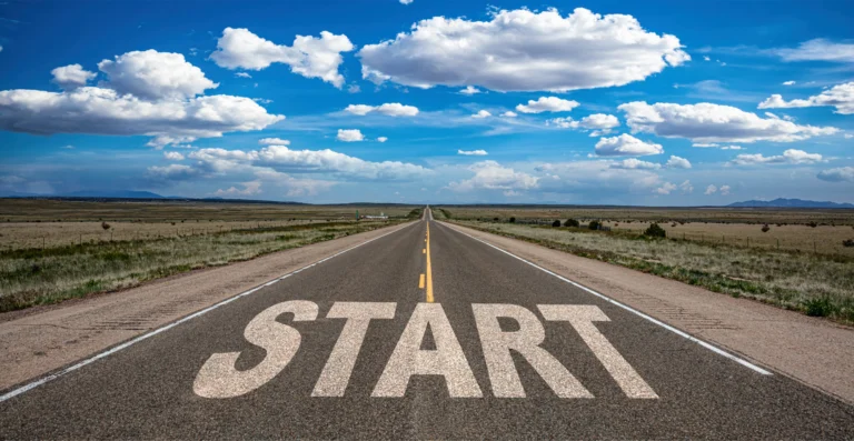 Long roadway with the word Start painted on the pavement, symbolizing how ADHD adults struggle to begin tasks.