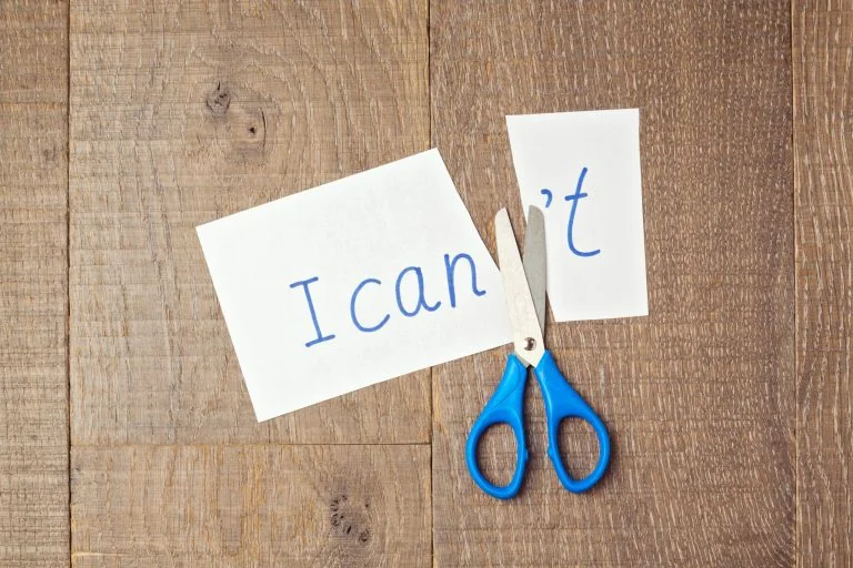 Picture with paper cut so it reads "I can" instead of "I can't" to illustrate motivation for ADHD adults.