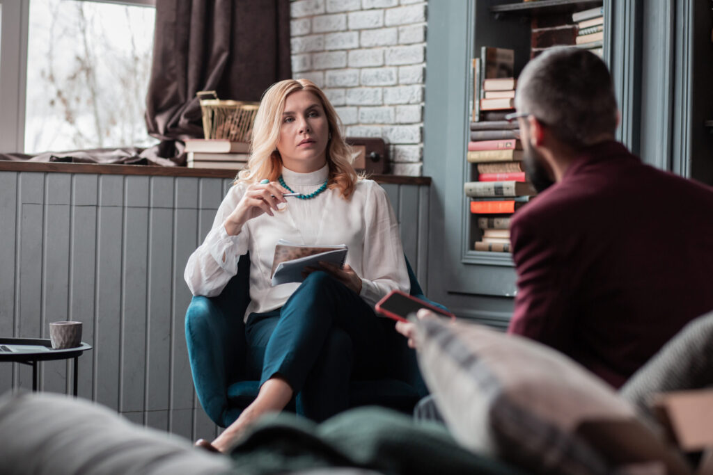 Therapist and client in conversation representing ADHD therapy versus coaching support