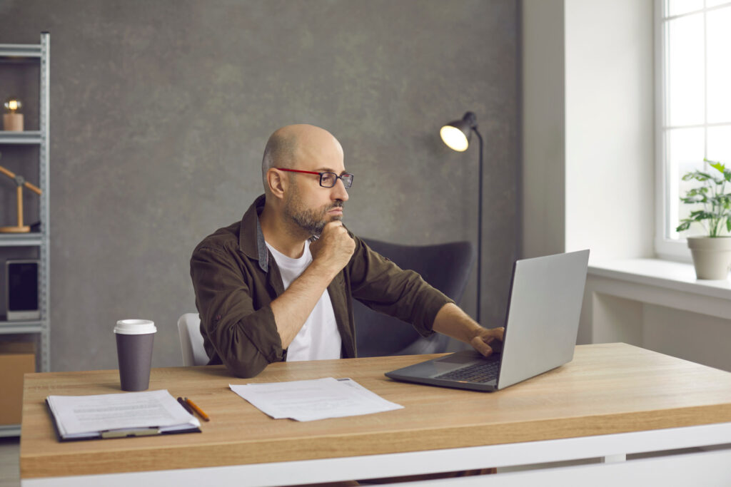Man with ADHD trying to write a difficult email, feeling stuck and unsure how to respond