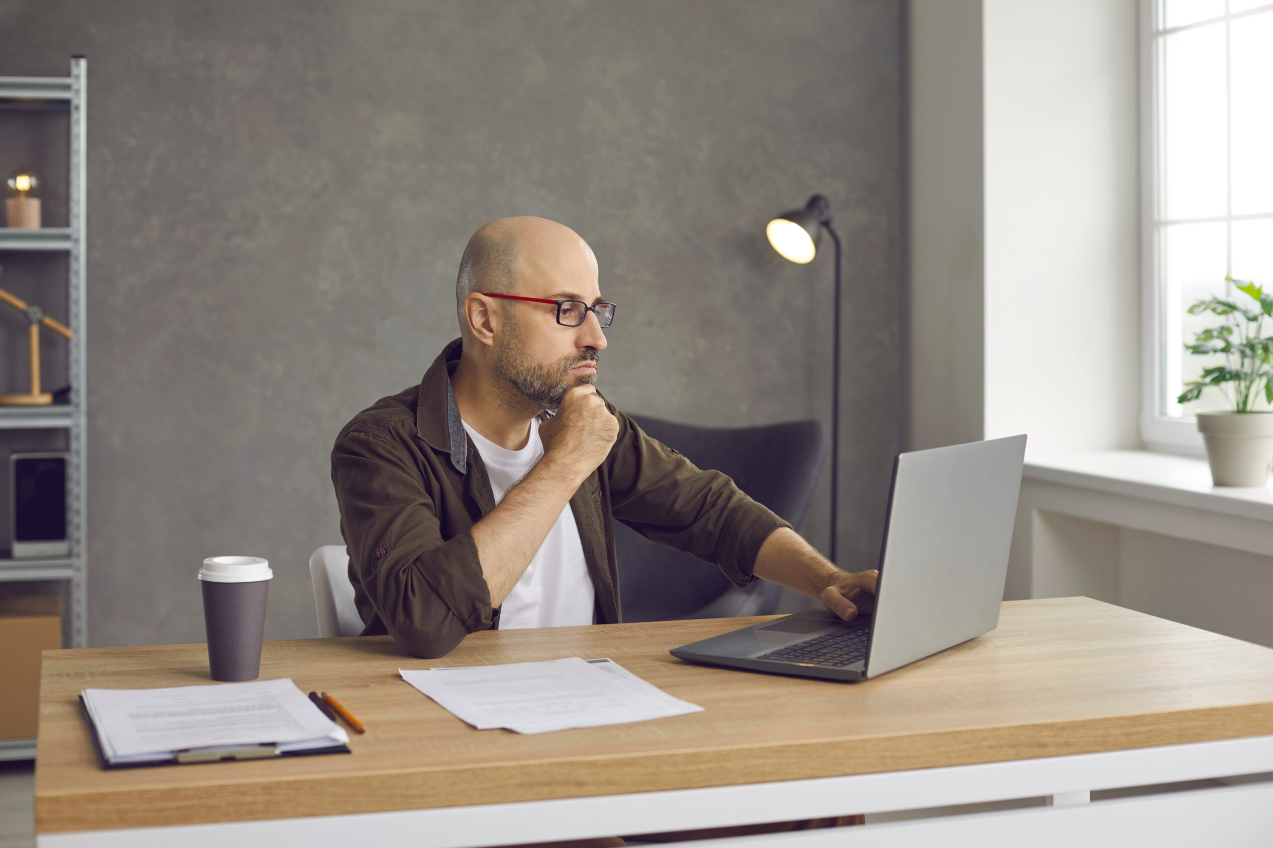 Man with ADHD trying to write a difficult email, feeling stuck and unsure how to respond