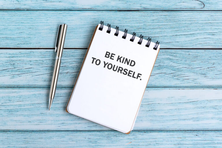 Notebook with message ‘Be kind to yourself’ showing how self-compassion can help build self-esteem and self-confidence for adults with ADHD.