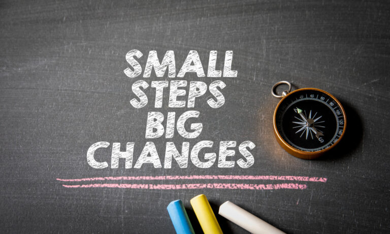 Chalkboard image showing “Small Steps, Big Changes” next to a compass, representing ADHD motivation through small intentional steps instead of urgency.