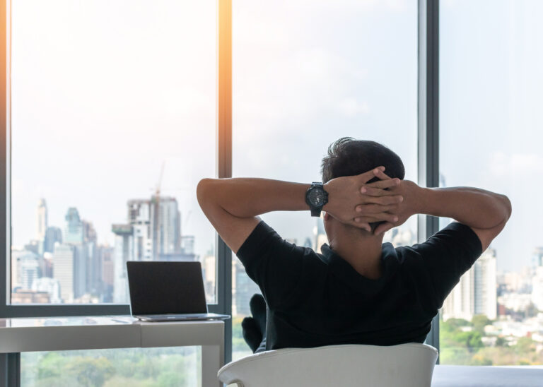 Man pausing at his desk to regulate stress and frustration related to ADHD