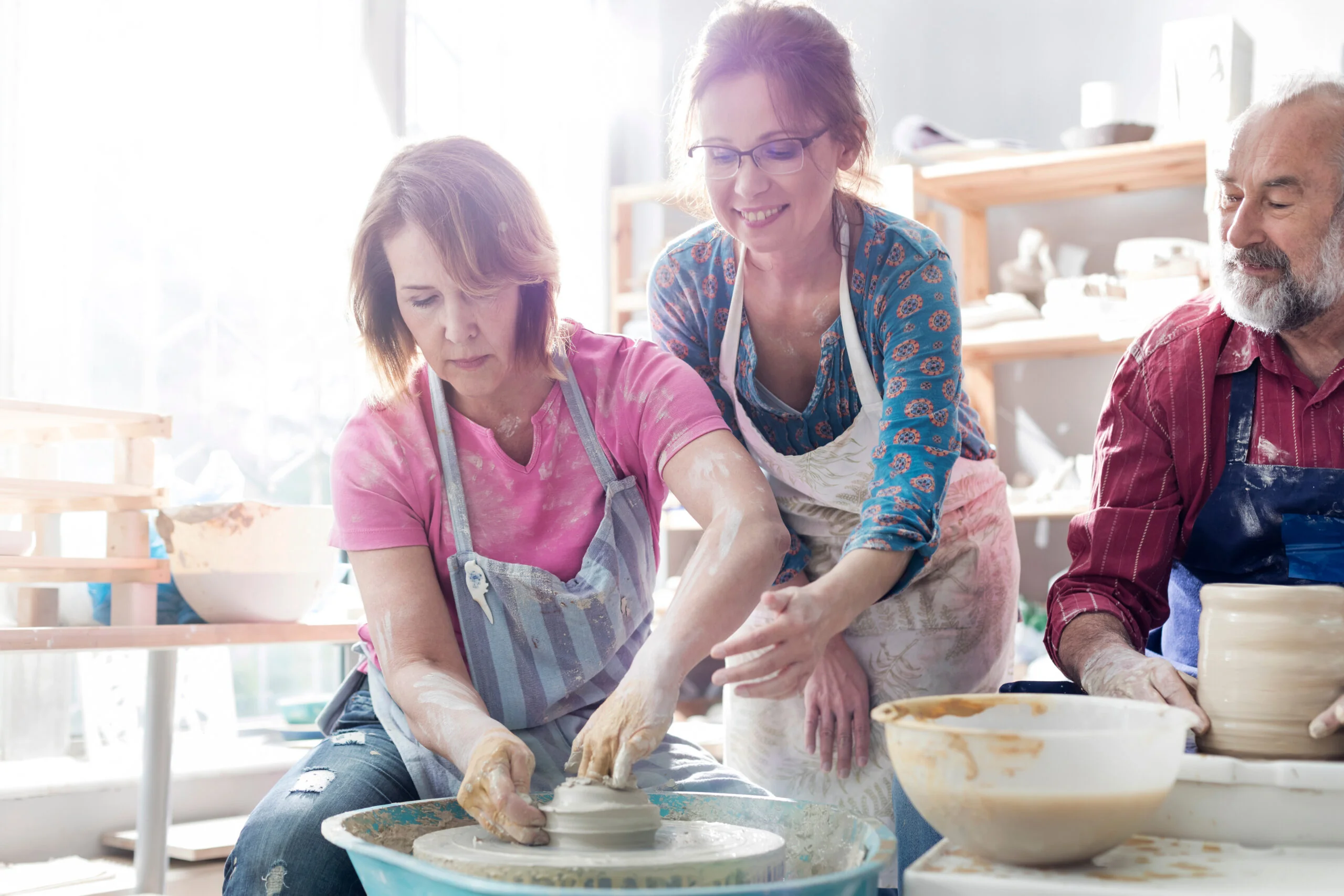 Adults learning pottery in a class, illustrating how ADHD perfectionism can make trying new activities feel difficult.