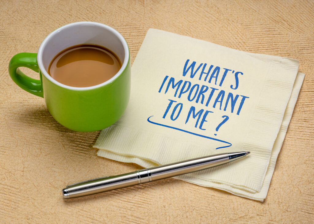 Coffee cup and handwritten note asking “What’s Important to Me?” representing ADHD prioritization and deciding what matters most.