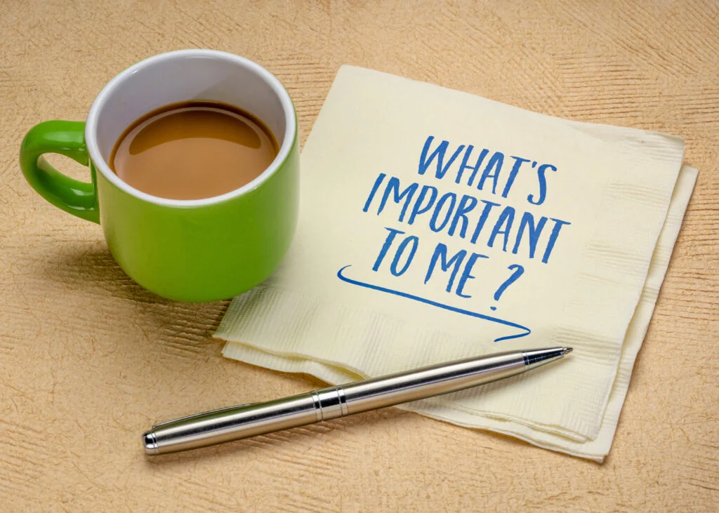 Coffee cup and handwritten note asking “What’s Important to Me?” representing ADHD prioritization and deciding what matters most.