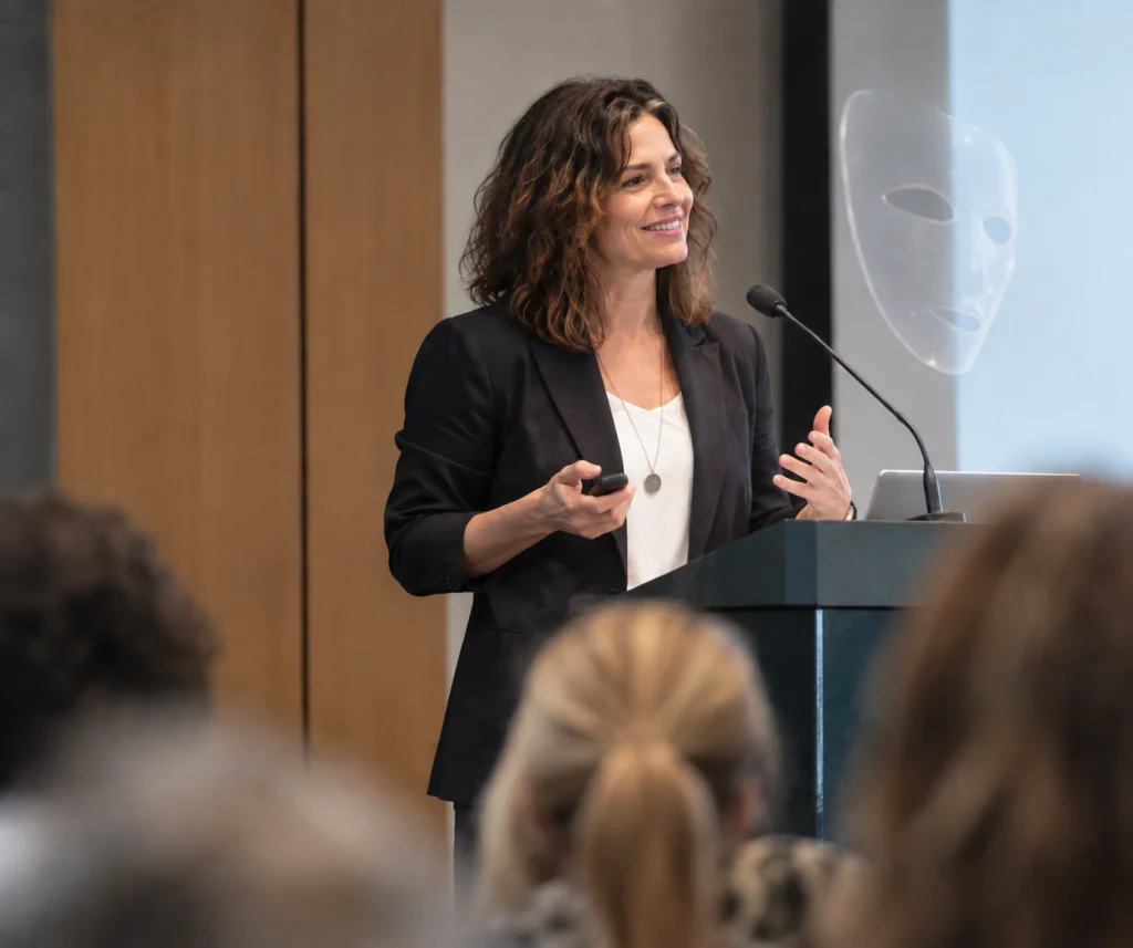 Woman speaking at a conference illustrating ADHD masking and how adults with ADHD may hide their symptoms